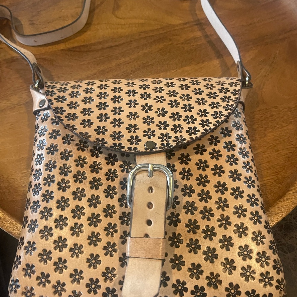 Tan Crossbody Bag with Floral Pattern and Flap Closure
